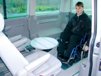 a picture showing a wheelchair user in the vehicle