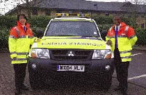 a picture of two of the highways agency staff standing at the side of the vehicle